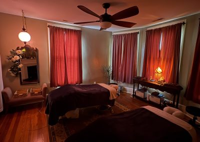 Wild Rose couples massage room with mirror, roses, and lamplight